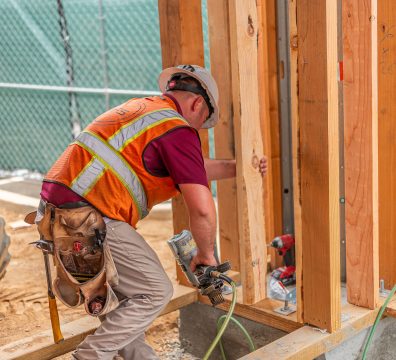 Building a house: wooden frame showcasing exposed beams and studs.