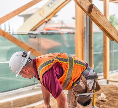 Visible wooden framework of a house under construction, with structural beams and studs