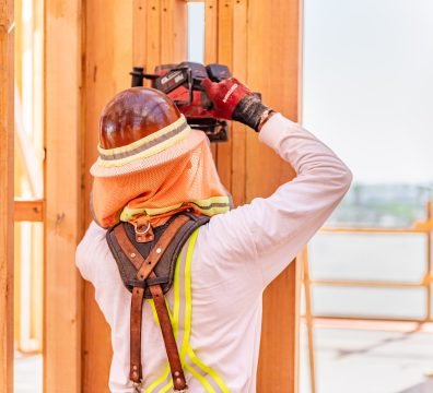The wooden skeleton of a house under construction, with beams and studs.