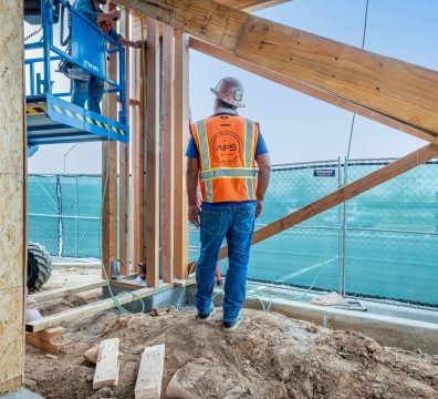 Visible wooden beams and studs forming the framework of a house under construction.