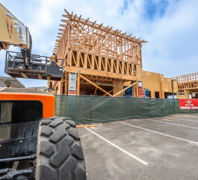 Partially built house showcasing the wooden frame with structural beams and studs.