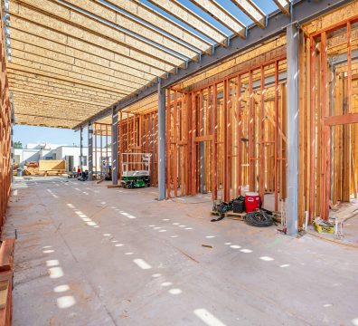Wooden framework of a house under construction, displaying beams and studs.