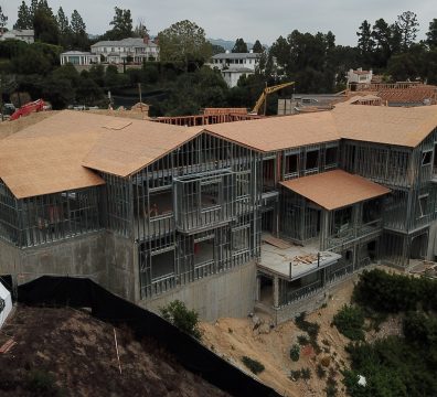 A house's wooden frame under construction, displaying beams and studs