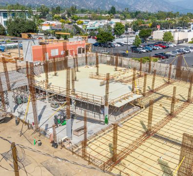 Wooden structure of a house under construction, featuring beams and studs