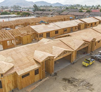 Wooden framework of a house, with exposed beams and studs during construction.