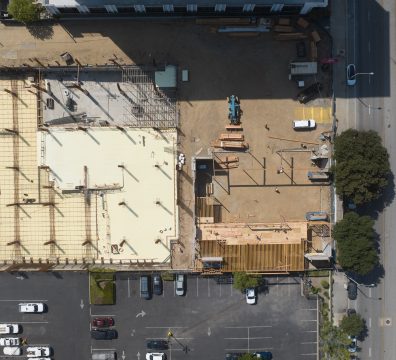 Construction site with a house frame made of wooden beams and studs.