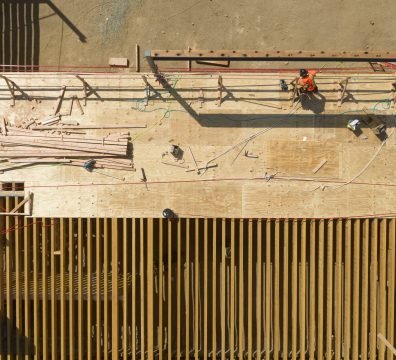 The visible wooden framework of a house under construction, with beams and studs