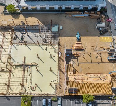 Construction of a house with a wooden frame, featuring visible beams and studs