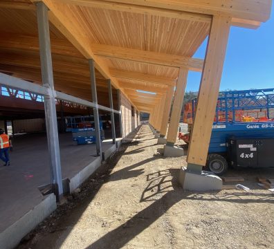 Partially completed house with a wooden frame showing beams and studs.