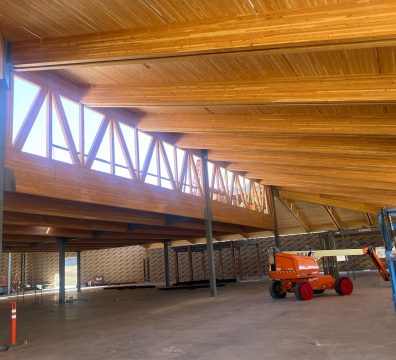 Construction phase of a house, featuring a wooden frame with exposed beams and studs.