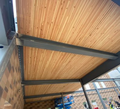 The framework of a house under construction, made of wooden beams and studs