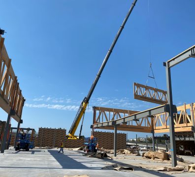 Wooden frame of a house, showing exposed beams and studs during construction.