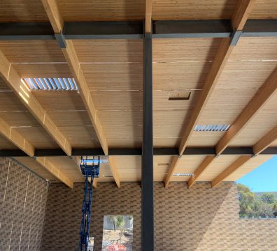Framing a house: wooden structure with exposed beams and studs under construction.