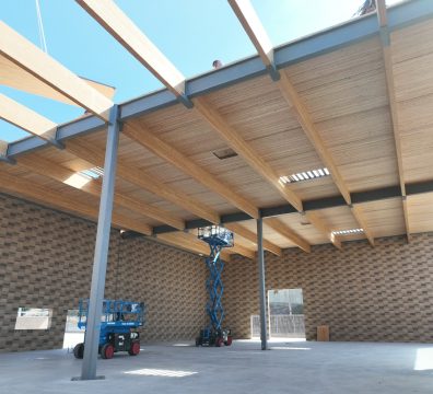 Visible wooden structure of a house in the framing stage, with beams and studs