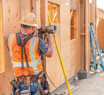 The visible wooden structure of a house in the framing stage, with beams and studs