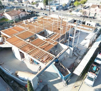 The wooden framework of a house, with beams and studs forming the structure