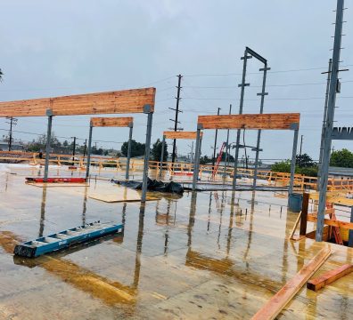 A house's skeleton frame made of wood, under construction with visible beams and studs.