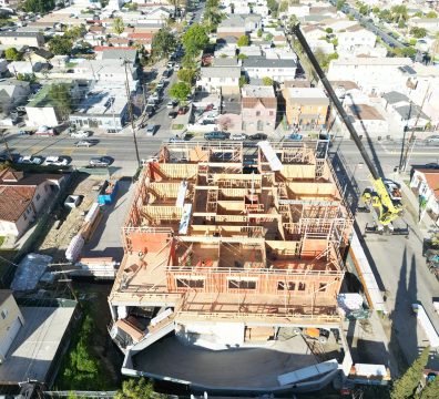 Construction site showcasing a house frame with wooden beams and studs.