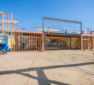 Visible wooden framework of a house, with beams and studs forming the structure.