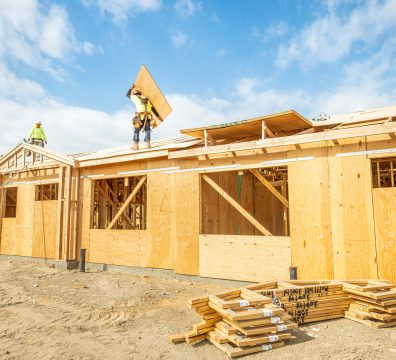House construction showcasing the wooden frame with visible beams and studs.