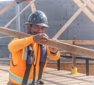 Wooden beams and studs forming the frame of a house under construction.