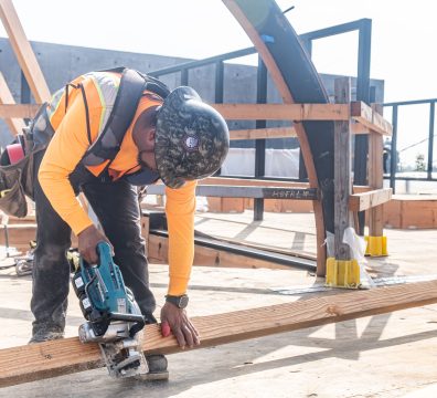 The framework of a house made of wooden beams and studs, under construction.