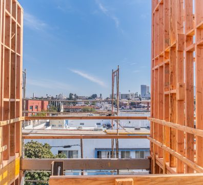Framing of a house: wooden beams and studs in place, ready for further construction.
