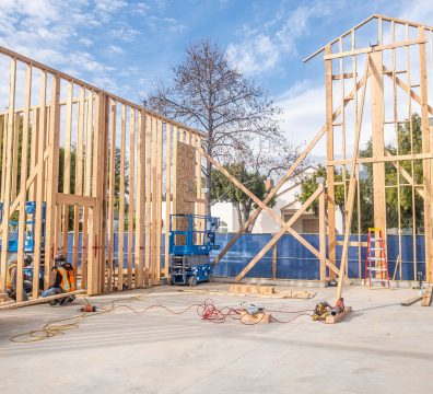 A partially built house with a wooden frame, displaying the walls