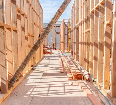 The skeleton of a house under construction, featuring wooden beams and studs