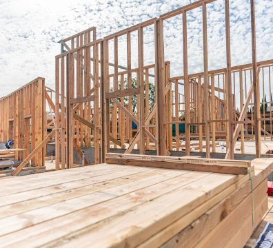 The exposed wooden framework of a house, showing the beams and studs forming its structure.